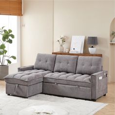 a living room with a gray couch and white rug