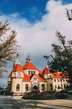 an orange and white building surrounded by trees