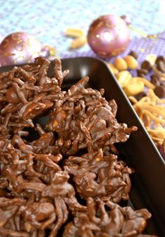 chocolate covered cookies in a pan on a table with other decorations and balls behind them