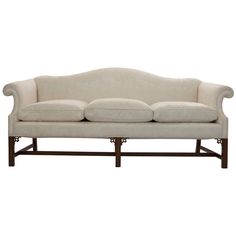 a white couch sitting on top of a wooden frame