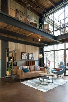 a living room filled with furniture and lots of windows