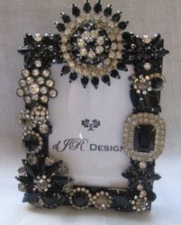 a black and white photo frame decorated with jewels