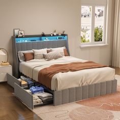 a bed with two drawers underneath it in a bedroom next to a window and rug