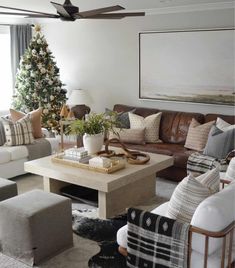 An extra large square coffee table takes center stage in this modern farmhouse game room. A mix of sofas, poufs, and chairs decked in patterned cushions surround the table for an eclectic and charming feel...   Image: houseofwahls