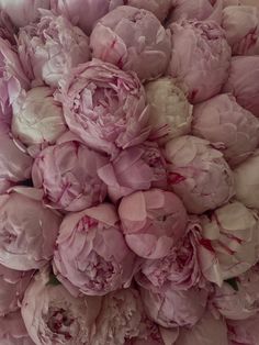 a large bouquet of pink peonies is shown in this close up view from above