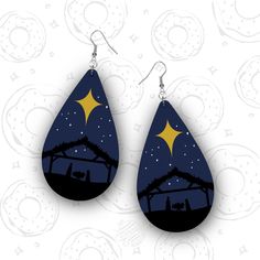 the nativity scene is depicted in this pair of drop earrings, which are hand painted with acrylic paint