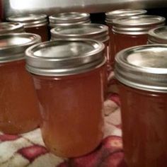 many jars are lined up on a towel