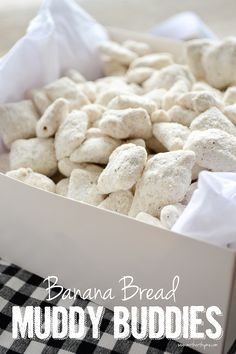 a box filled with white puppy chow next to a black and white checkered table cloth