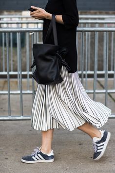 You can't go wrong with a pair of adidas gazelles. Wear them with a pair of boyfriend jeans for relaxed vibes or a striped skirt like this one for a 90s look. Rok Midi, Looks Adidas, Rok Outfit, Walking Down The Street, Style Casual Chic, Striped Midi Skirt, Looks Street Style, Street Style Trends, 가을 패션