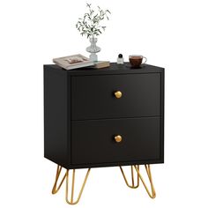 a black nightstand with gold legs and a potted plant sitting on top of it