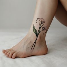 a woman's foot with a flower tattoo on it