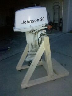 a white machine sitting on top of a wooden stand