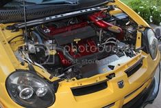 the engine compartment of a yellow sports car