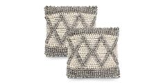 two gray and white pillows on top of each other, one is made out of woven material