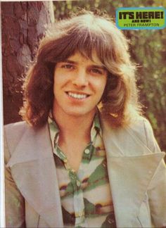 an old photo of a man with long hair and wearing a jacket smiling for the camera