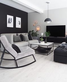 a living room filled with furniture and a flat screen tv mounted to the side of a wall