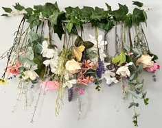 an arrangement of flowers hanging on a wall