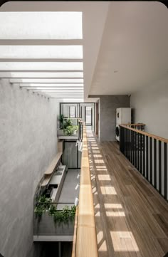 an empty room with wooden floors and white walls is seen from the second floor looking down