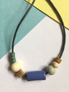 Minimal and modern ceramic bead statement necklace!  All Longleaf Supply Co. jewelry is made with beads from around the world: Greek & African ceramic beads, wooden beads, and sturdy waxed cotton cord.  This necklace is a little smaller than other chunky bead statement necklaces (still fun while not being too loud or heavy around your neck!). It's great as a gift, or an easy way to dress up an outfit. Default length is a 30" waxed cotton cord--a nice medium-long length. You can add a message at Wooden Bead Jewelry, Ceramic Bead Jewelry, Ceramic Beads Necklace, Too Loud, African Accessories, Chunky Bead Necklaces, Beads Pictures, Chunky Beads, Beaded Statement Necklace