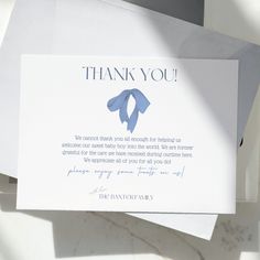 a thank card with a blue ribbon on it