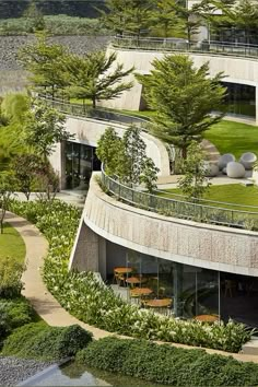 an aerial view of a circular building surrounded by greenery