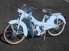 a blue motorcycle is parked on the pavement