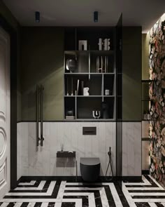 a bathroom with black and white tile flooring next to a tall book shelf filled with books