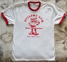 BULLDOG GYM New York City Short Sleeved Ringer T-shirt. Brand New without tag. Sizes Available: Medium, Large and Extra Large. 100% Cotton. Gym T Shirt Design, Old School Bodybuilding, Vintage Athletic Wear, New York City Vintage, Sports Tshirt Designs, Fun Shirts, Gym Tees, City Shorts, Bodybuilding Workout