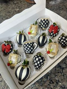 a box filled with chocolate covered strawberries on top of a counter