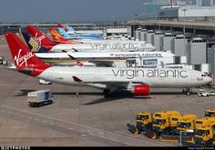 several airplanes are parked on the tarmac at an airport with other vehicles around them