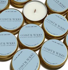 several candles sitting on top of each other with the words coastal waves written in them