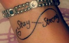 a wrist tattoo with the words stay strong written on it