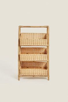 a wooden shelf with three wicker baskets on the bottom and two shelves below it