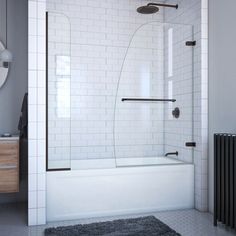 a bathroom with a white tiled wall and black accents on the floor, along with a bathtub