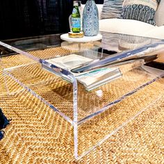 a glass coffee table sitting on top of a rug