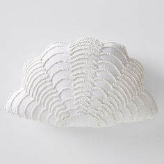 a white cloud shaped pillow sitting on top of a table