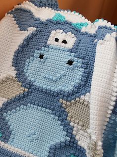 the crocheted blanket is made to look like stitching with characters on it