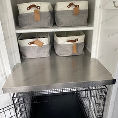 two baskets are on top of the shelf above the dog crate in the pantry area