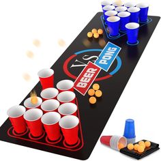 the beer pong game is set up with plastic cups and blue cones on it