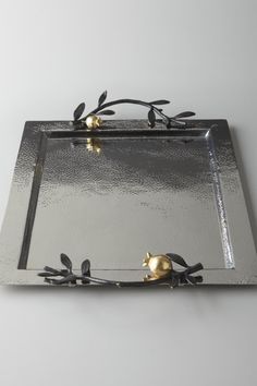 a metal tray with two birds on it