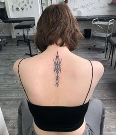 a woman with a tattoo on her back