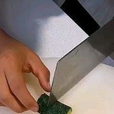 a person cutting up some food with a knife