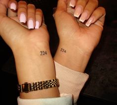 two girls with matching tattoos on their wrist