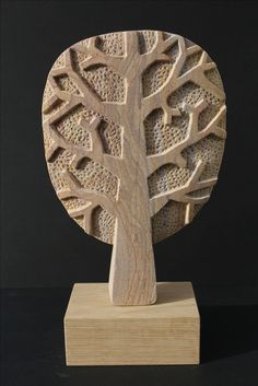 a carved wooden sculpture with a tree on it