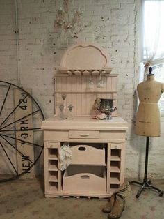 an old fashioned dresser is next to a mannequin