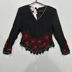 Add A Touch Of Vintage Glamour To Your Eveningwear With This Stunning Laurence Kazar Top. The Black Sequin Material Is Adorned With Intricate Embroidery, Making It A Unique And Eye-Catching Piece. The Long Sleeves And Petite Size Make It Perfect For A Cocktail Party Or A Special Occasion. It Is An Original Piece From The 1980s, Adding A Touch Of Nostalgia To Your Wardrobe. The Top Is Made In India And Is Perfect For Those Who Appreciate Quality And Style. Sequin Material, Intricate Embroidery, Vintage Glamour, Black Sequins, Petite Size, Poinsettia, Vintage Tops, Evening Wear, Cocktail Party