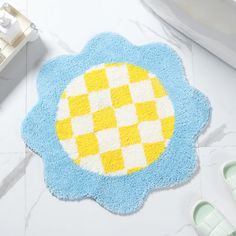 a blue and yellow bathroom rug on the floor