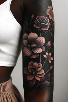 a woman's arm with flowers on it and a white shirt behind the arm