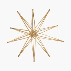 a star shaped object made out of wooden sticks on a white background with no one around it