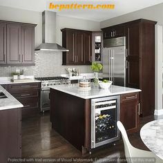 a kitchen with wooden cabinets and white marble counter tops